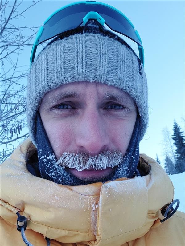 Sebastian Andersson wearing a hat, sunglasses, and has a frozen mustache.